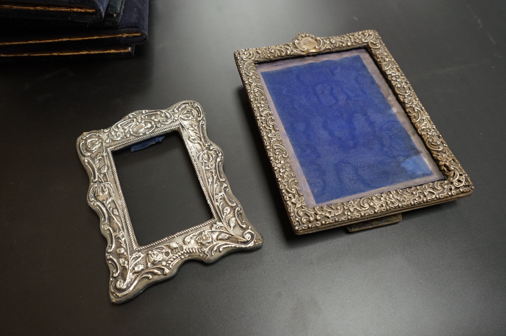 A late Victorian repousse silver mounted rectangular photograph frame, Birmingham, 1898, 17.9cm, a smaller Edwardian silver mounted photograph frame, Williams Ltd, Birmingham, 1905 and a set of four modern silver mounted